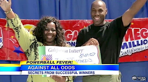 Cynthia Stafford Holding Large Cheque on TV News