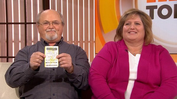 Lisa and John Robinson Holding Winning Ticket