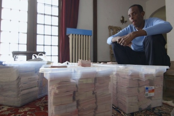 Lottery Addict Adam Osmond With Bins of Tickets