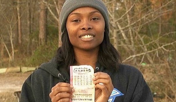 Marie Holmes Holding Winning Ticket