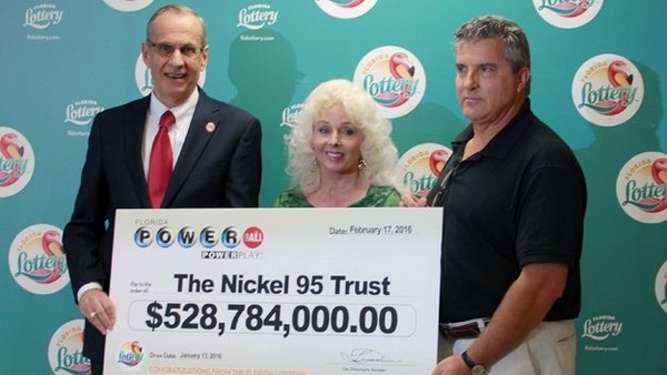 Maureen Smith and David Kaltschmidt Holding Oversized Cheque