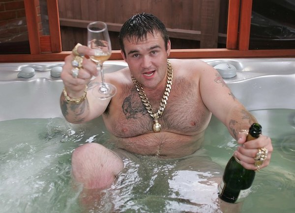 Michael Carroll with Gold Chain and Jewelry Holding Champagne in Hot Tub